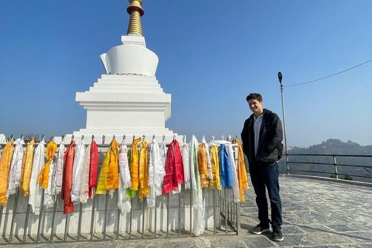a man standing next to a fence next to a temple
