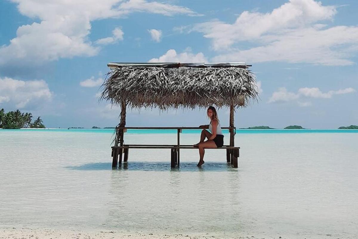 a woman sitting on a table in the water