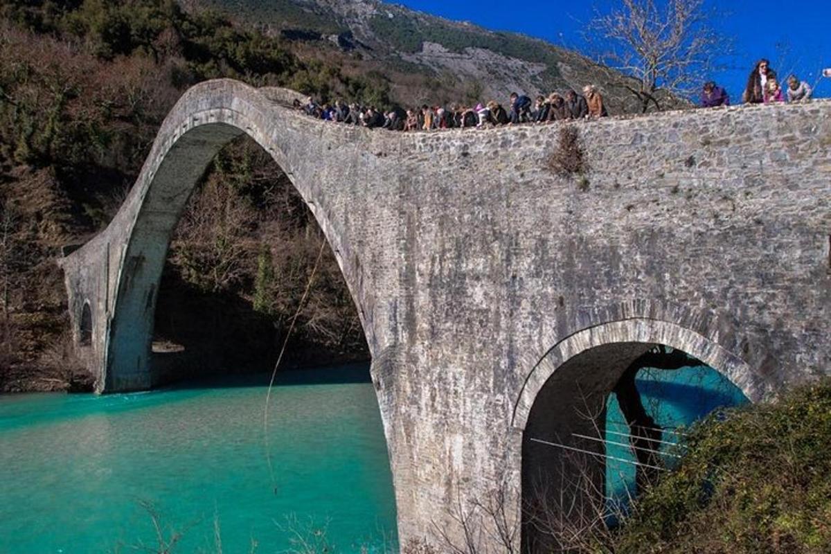 a group of people standing on a bridge over water