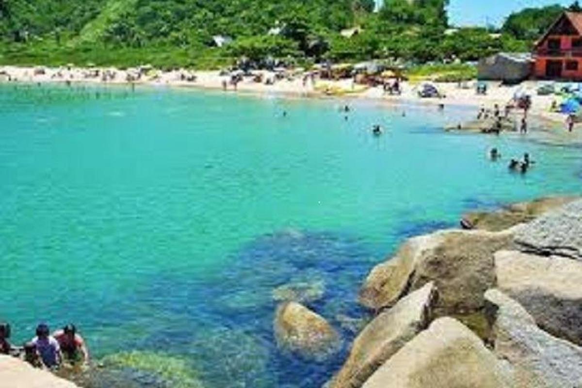 a group of people in the water at a beach