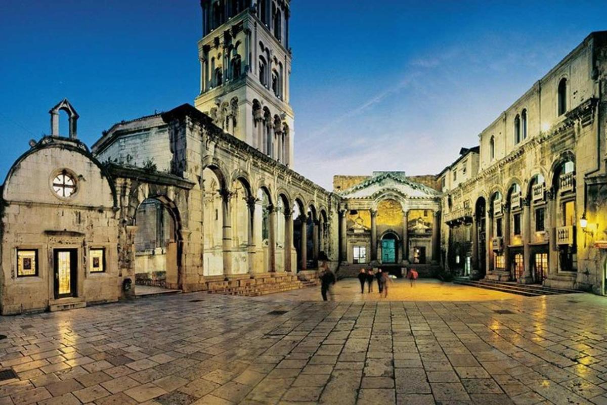 a large building with a clock tower in a courtyard