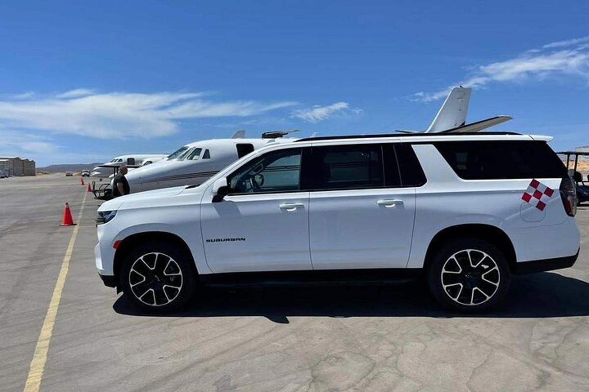 a white suv parked in a parking lot