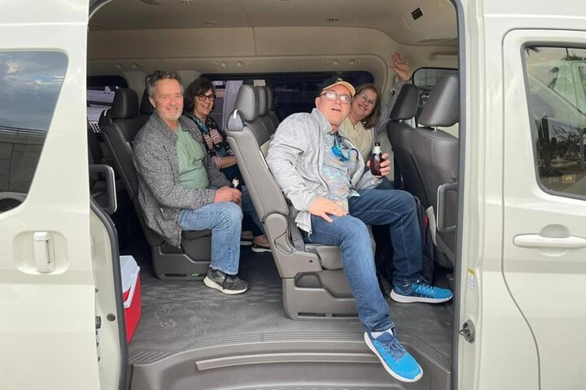 a group of people sitting in the back of a van
