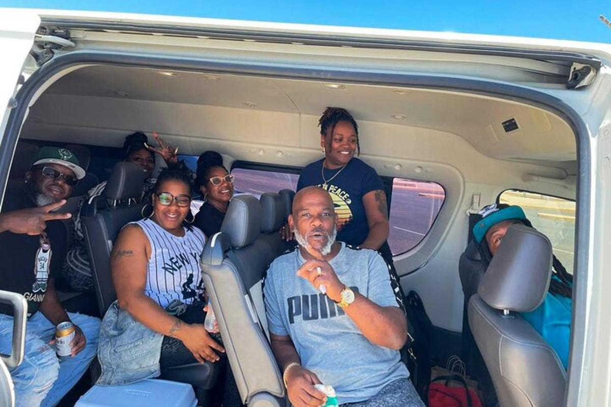 a group of people sitting in the back of a van