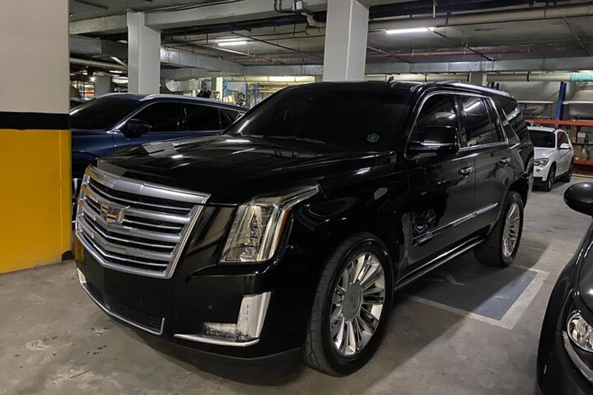 a black limousine parked in a parking garage