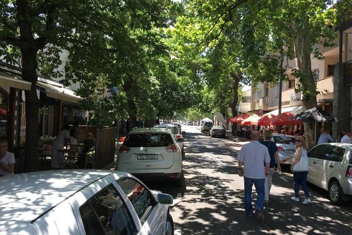 um grupo de pessoas caminhando por uma rua com carros