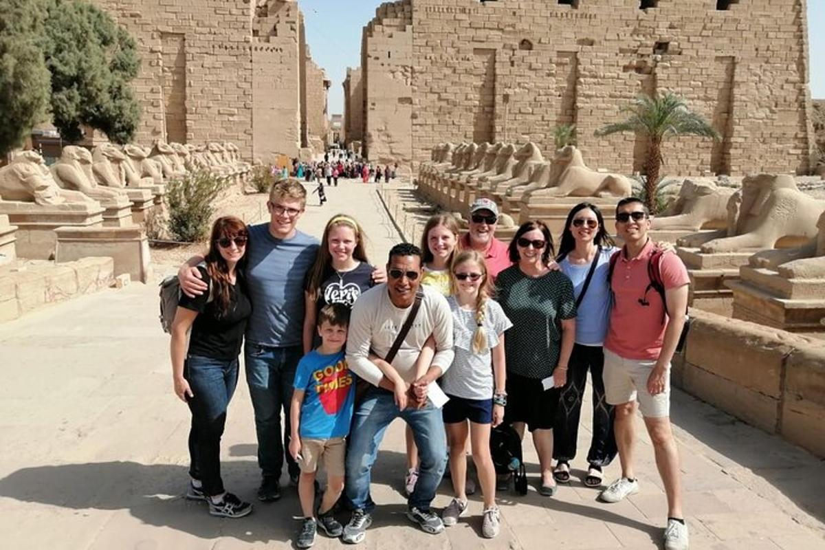 a group of people posing for a picture in front of a building