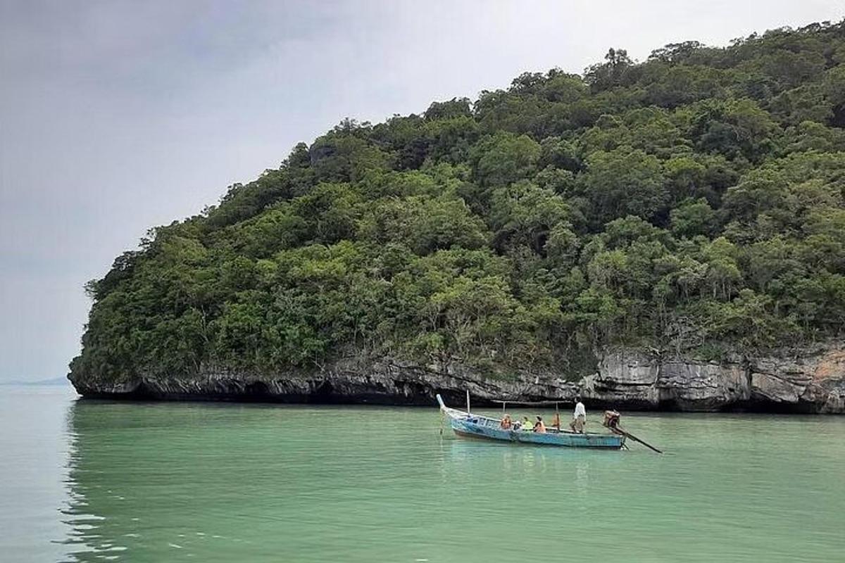 a group of people in a boat in the water