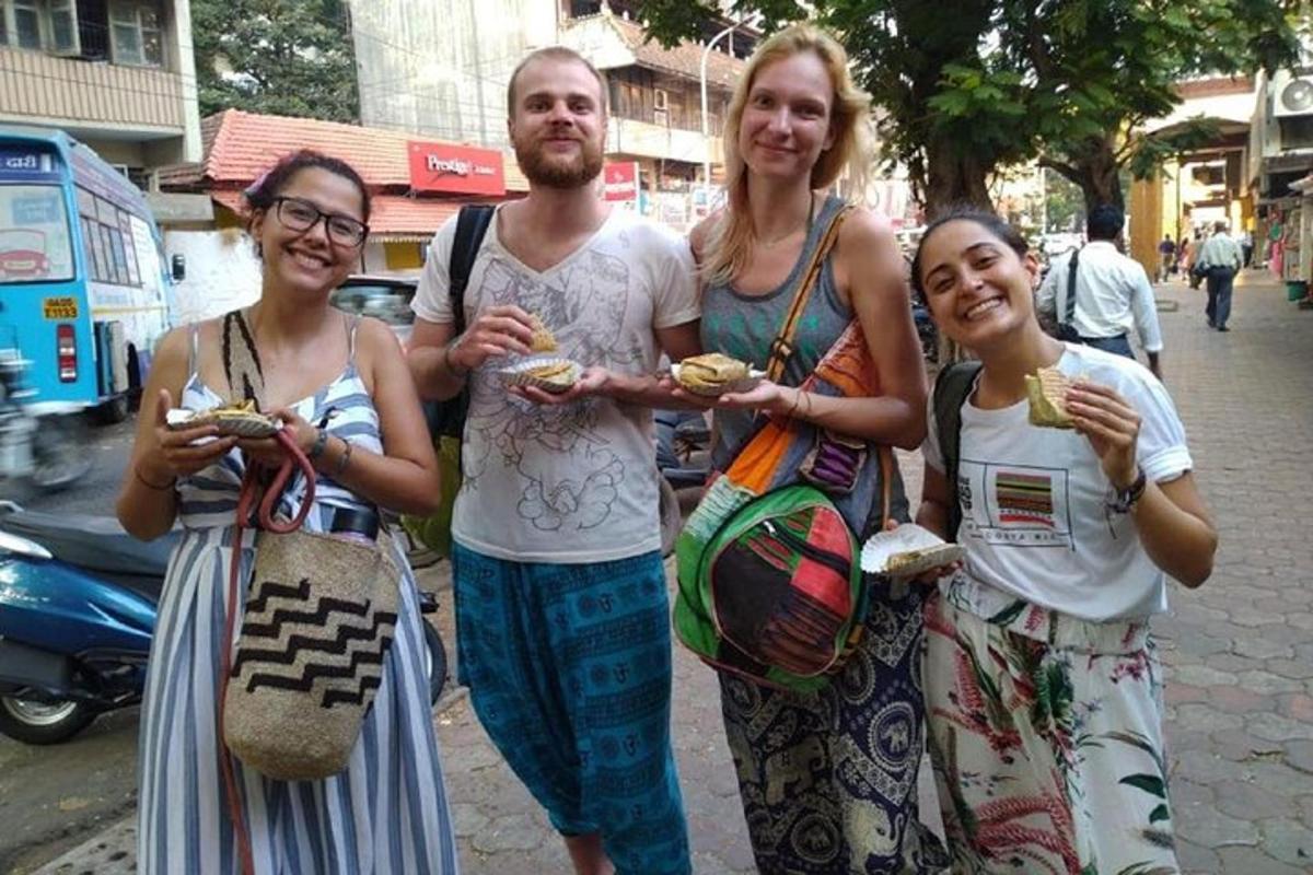 a group of people standing on a street with food