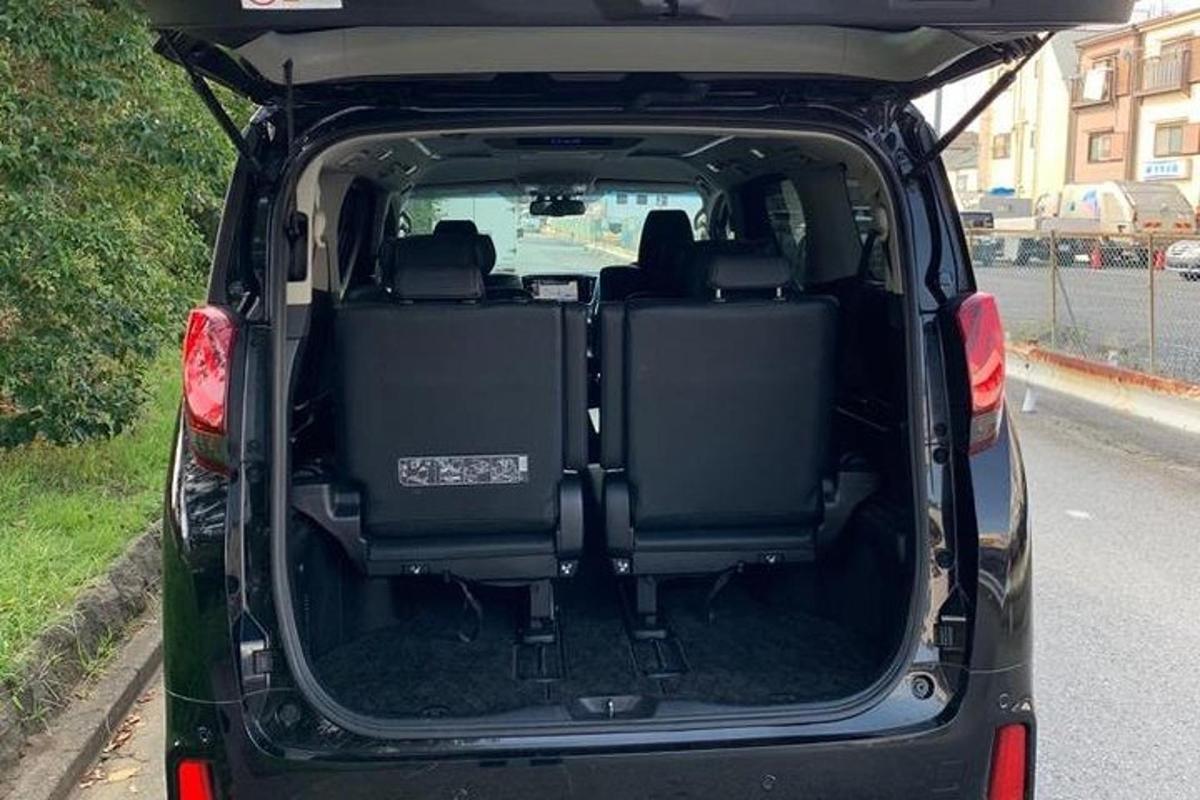 a car with its trunk open on a road