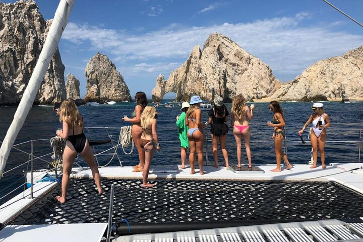 a group of women standing on a boat in the water