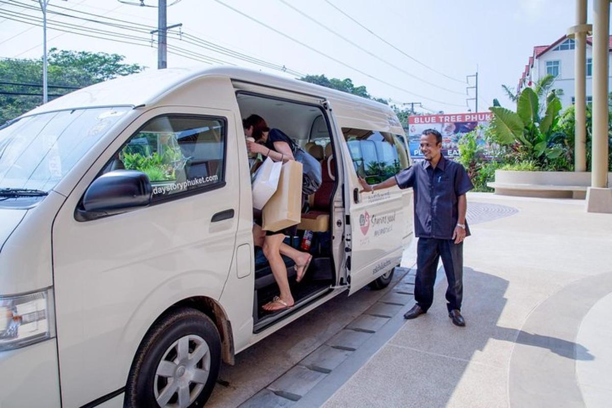 a man standing next to a van with people inside