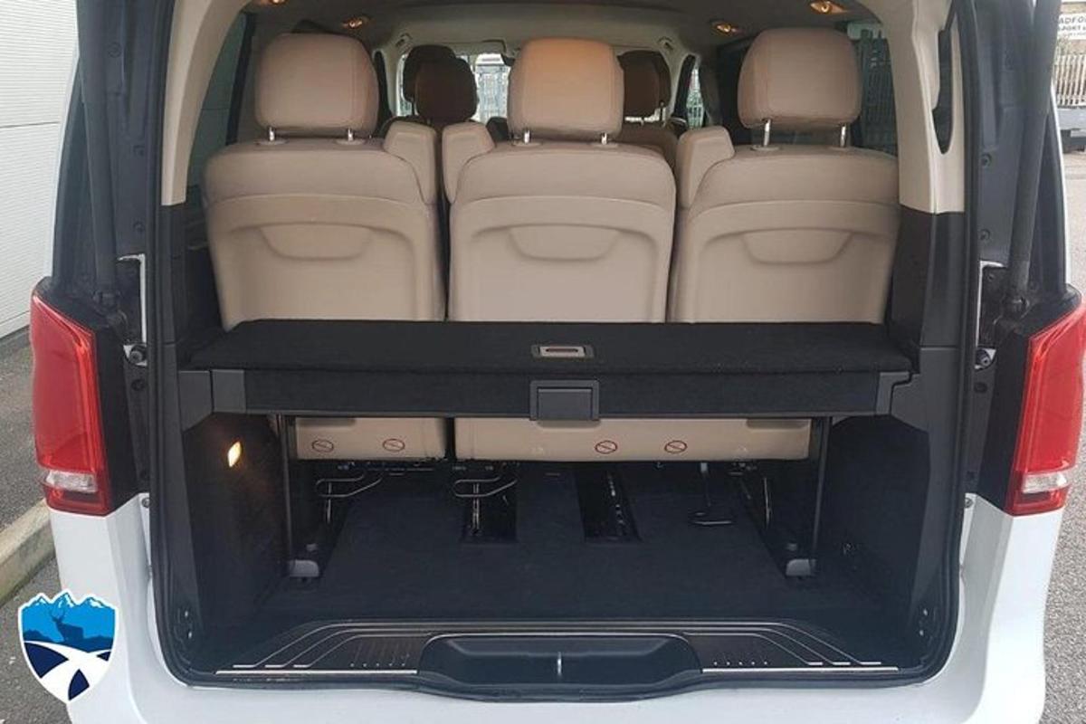 an open trunk of a car with the back doors open