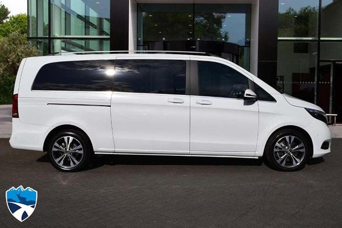 a white van parked in front of a building