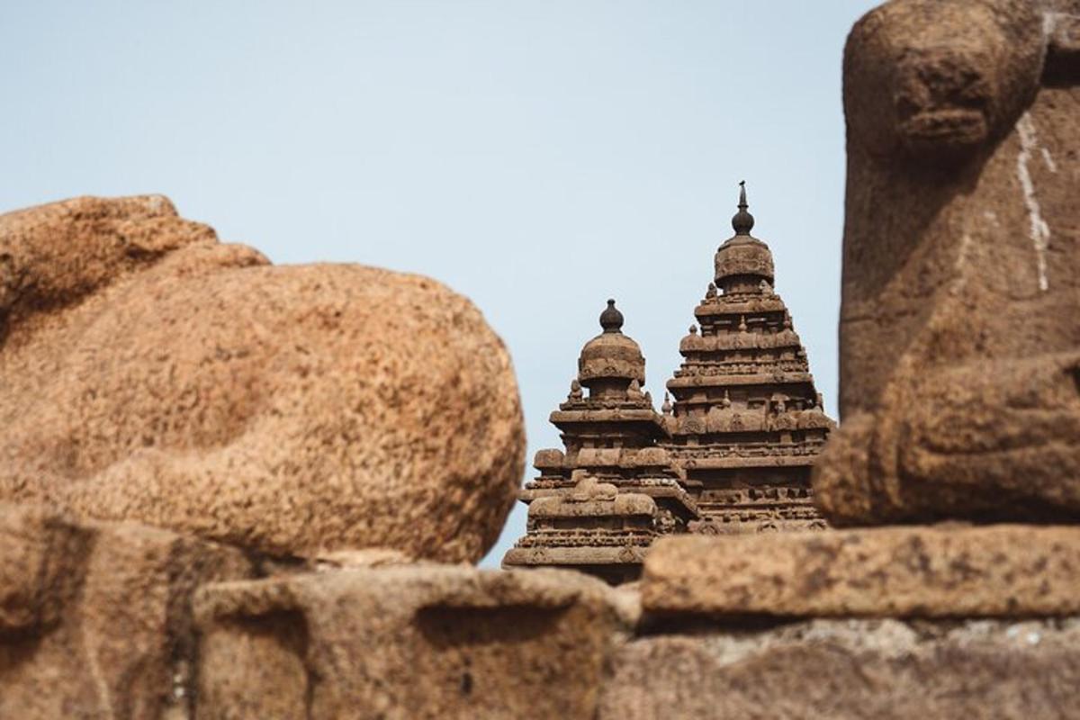 a stone wall with two towers in the background