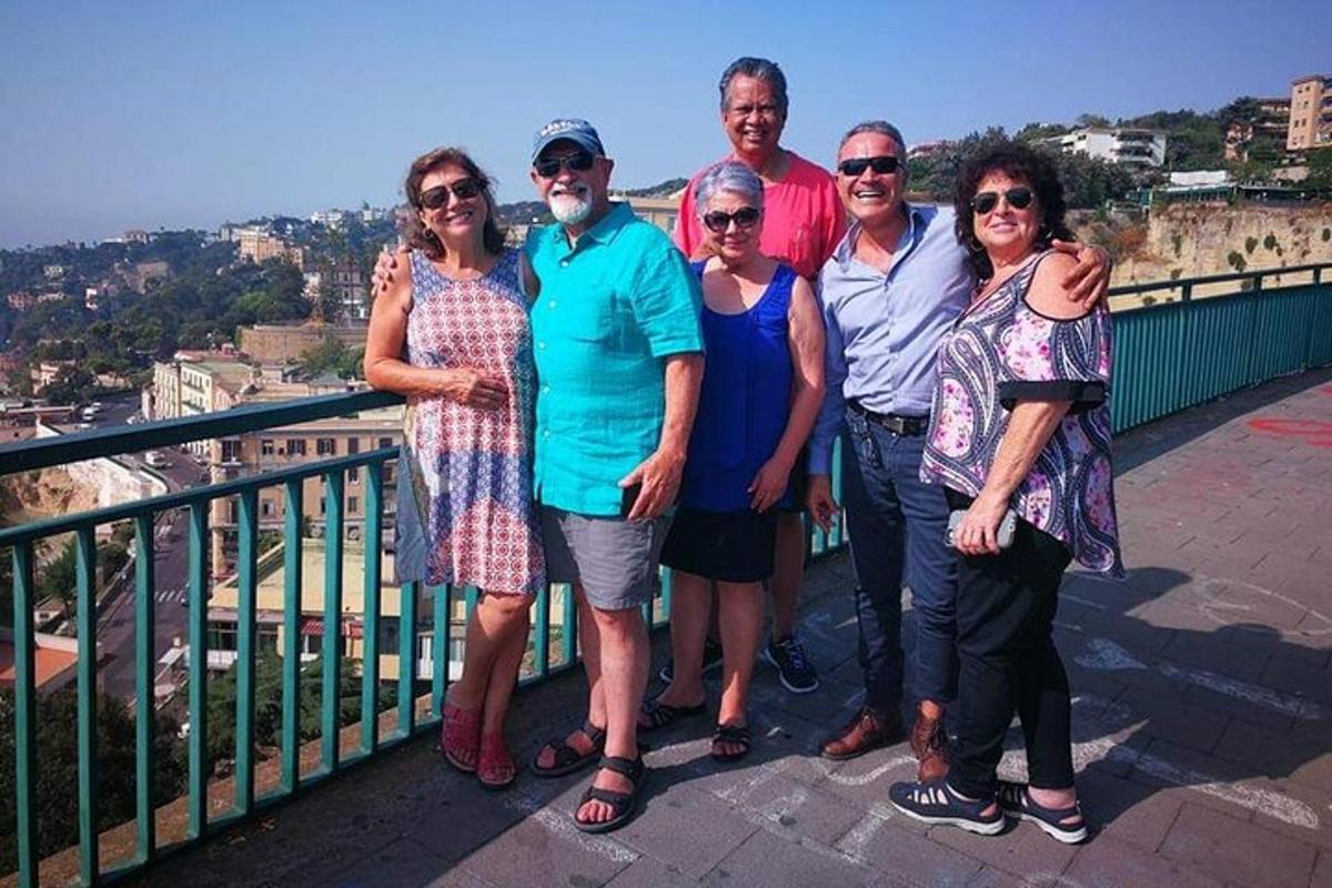 a group of people posing for a picture on a balcony