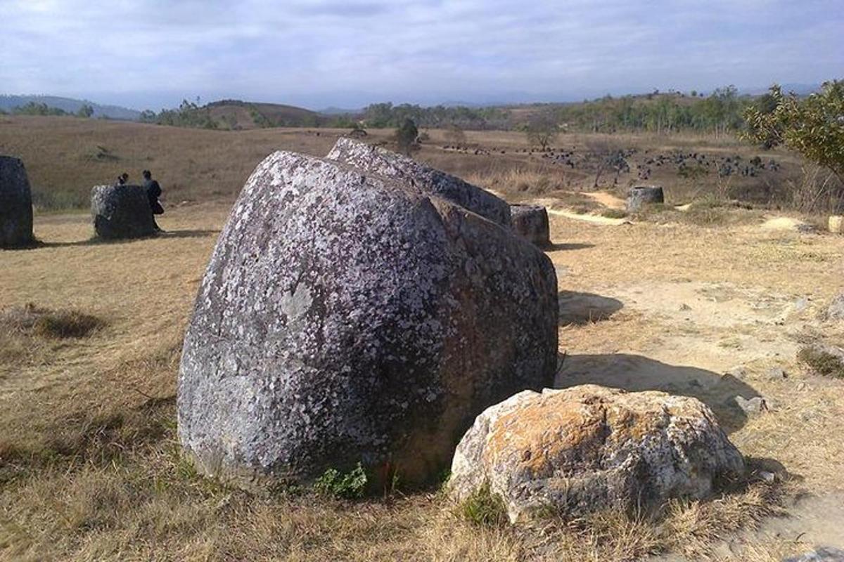 a large rock in the middle of a field