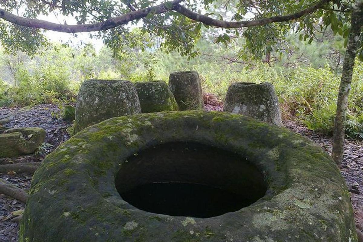 a large stone structure with a hole in the ground