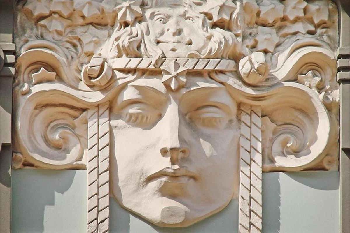 a statue of a cross on the side of a building