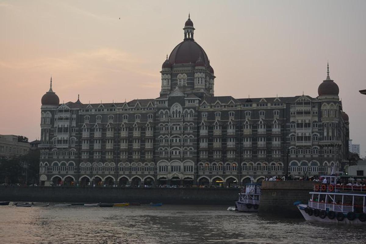 a large building next to a river with boats in it