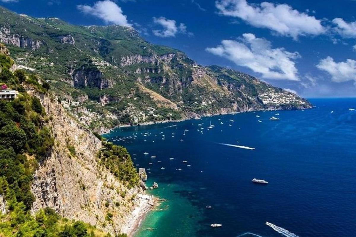 a view of a mountain with boats in the water