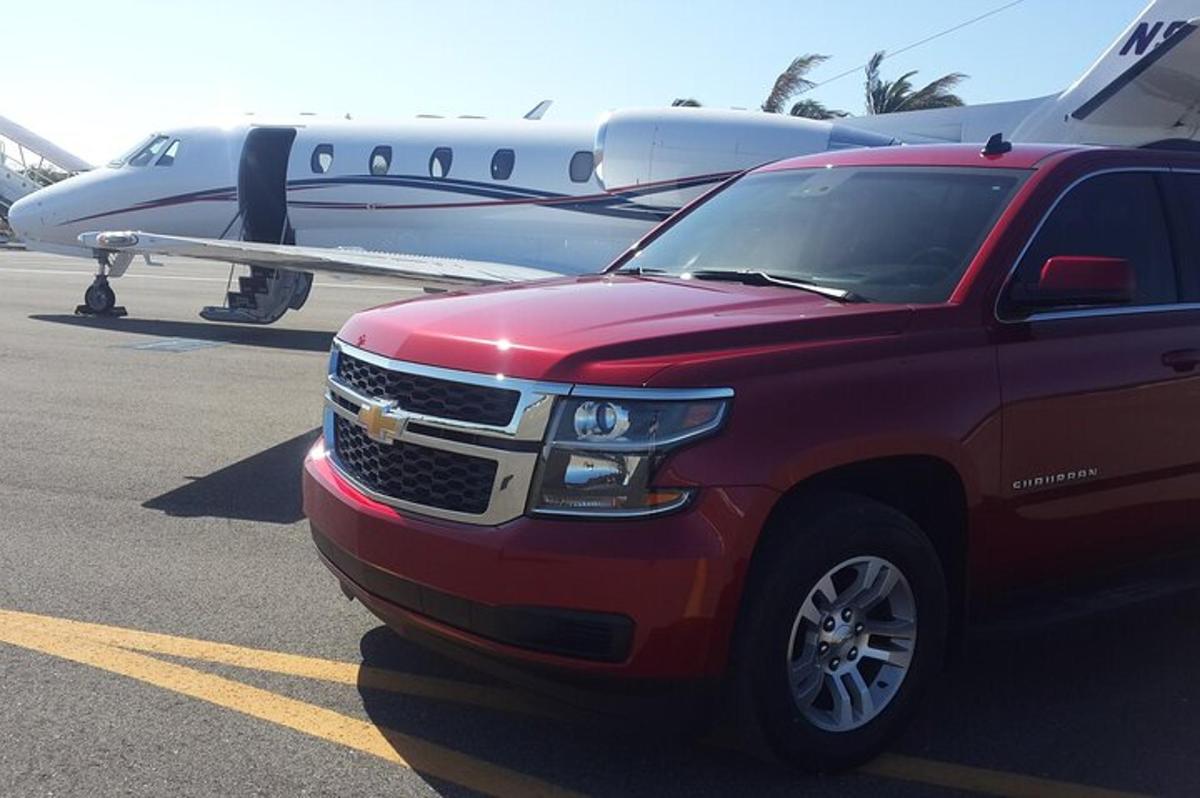 a red truck parked in front of an airplane
