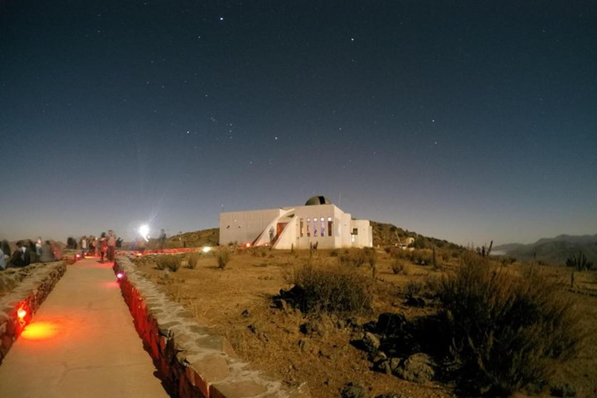 a building in the middle of a desert at night