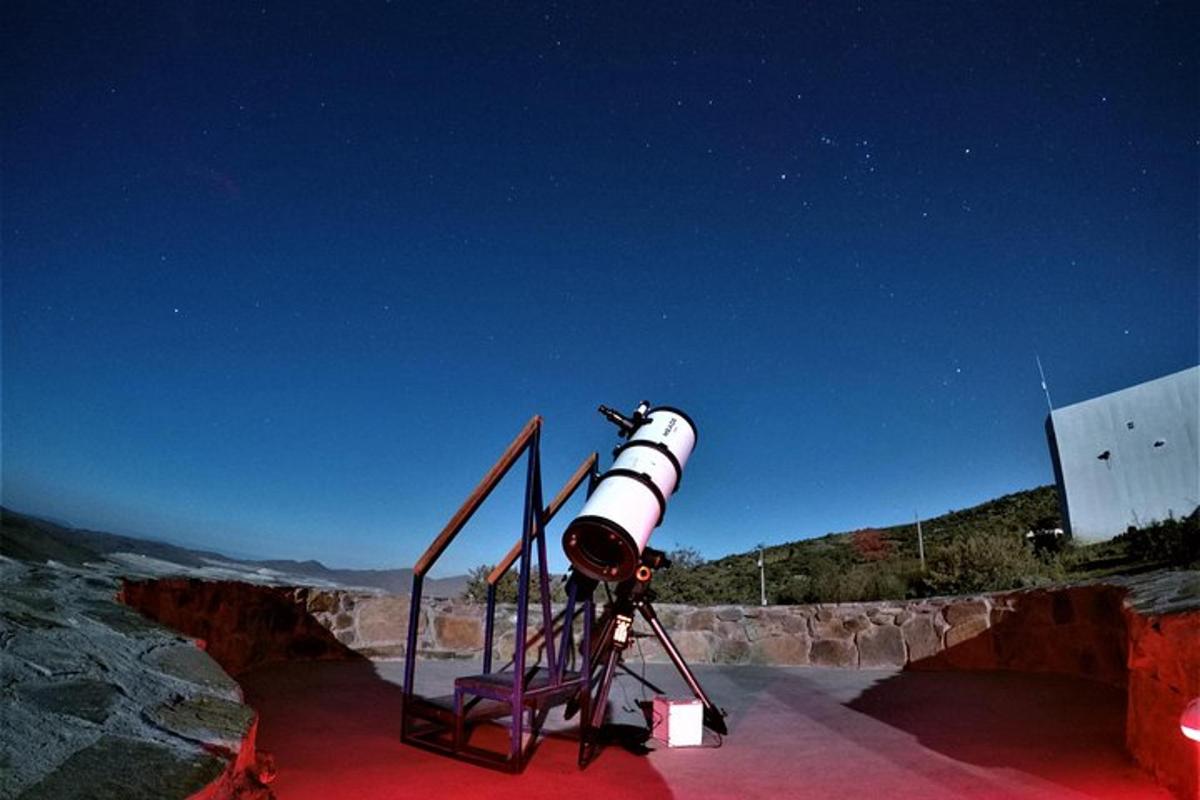 a telescope sitting on top of a red object