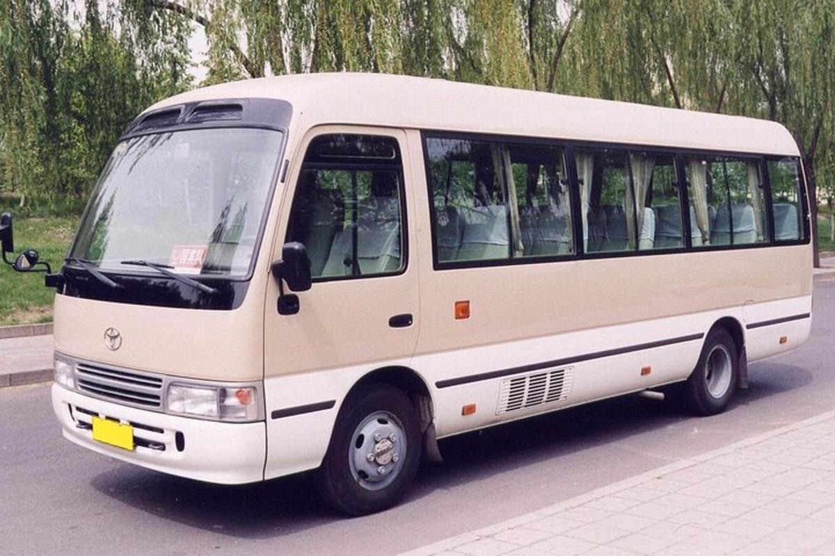 a white bus is parked on the street