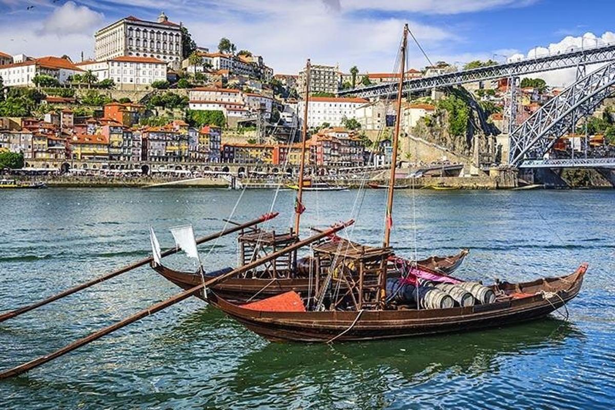 a boat with two oars in the water near a city