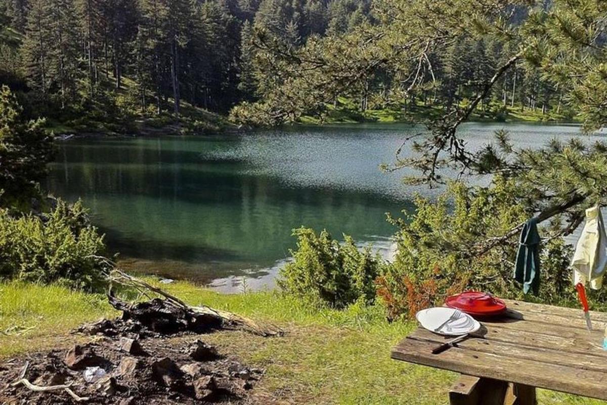 a picnic table sitting next to a lake