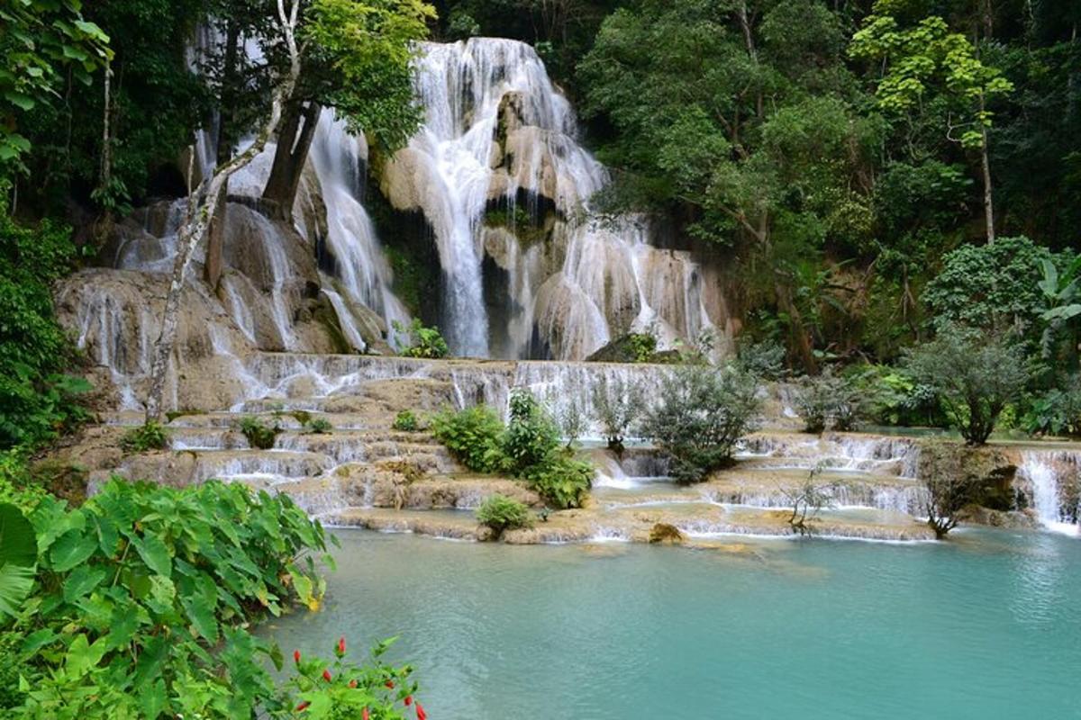 a waterfall in the middle of a pool of water
