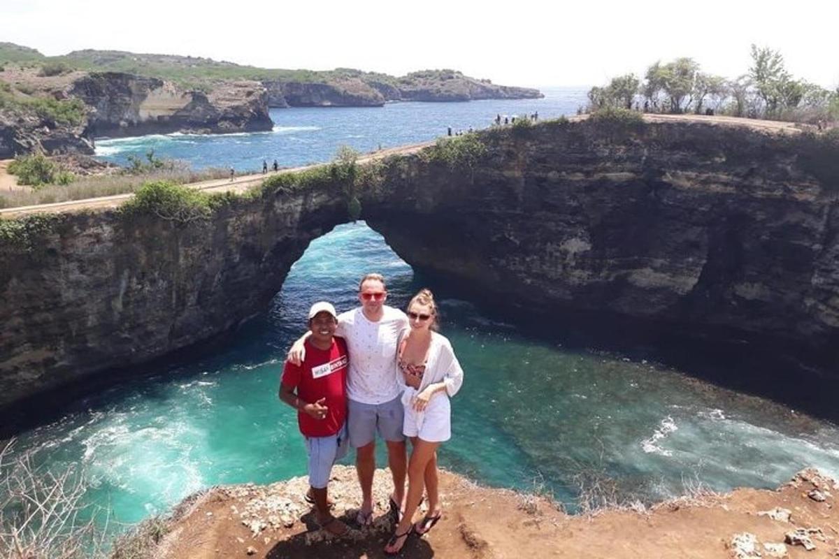 a group of people standing in front of a cave