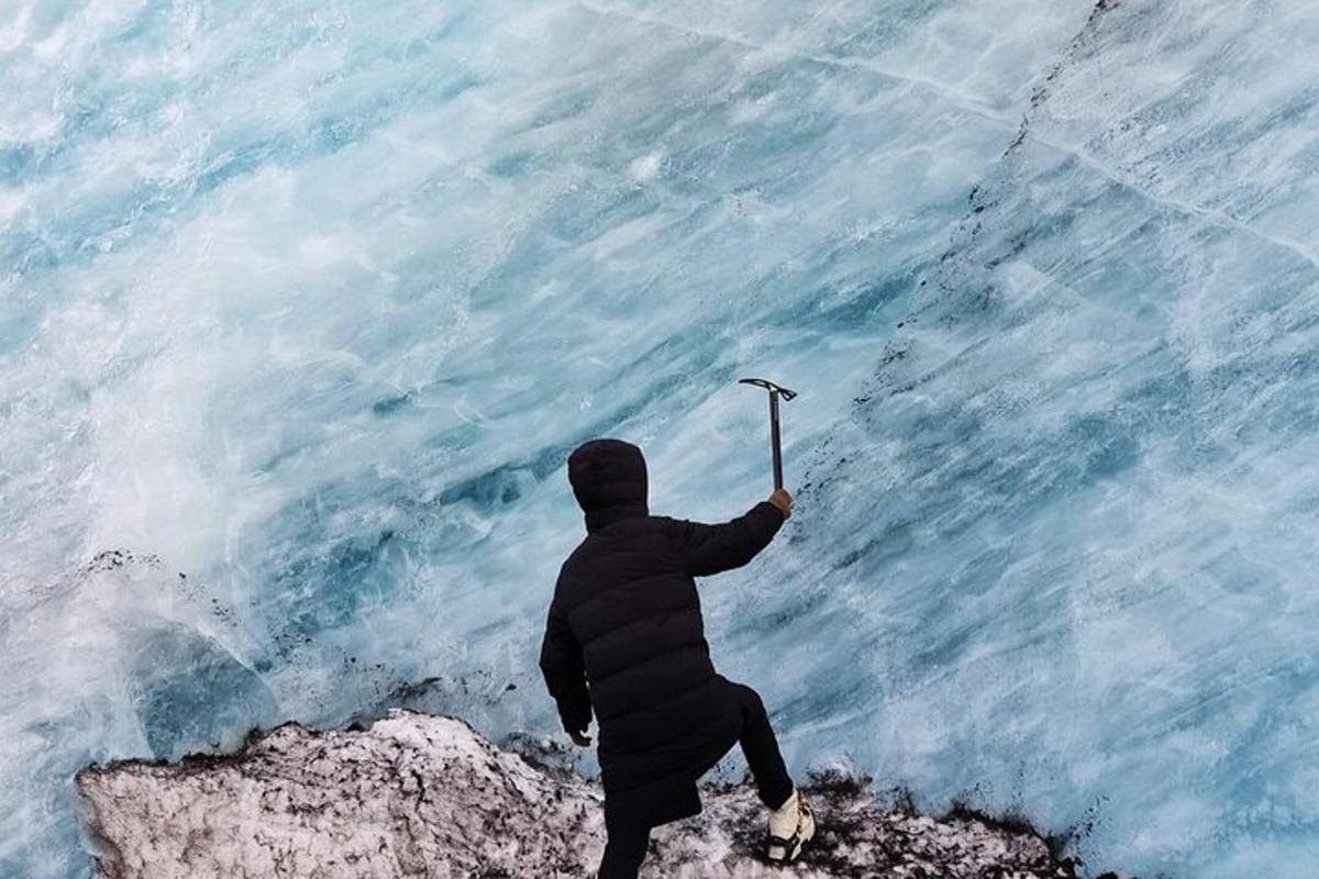 a person standing on top of a mountain holding a knife