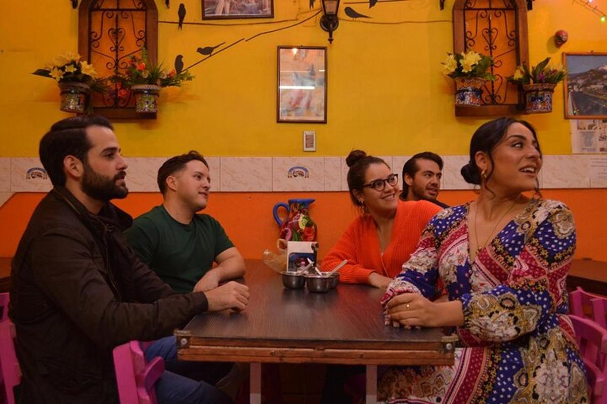 a group of people sitting at a table in a restaurant