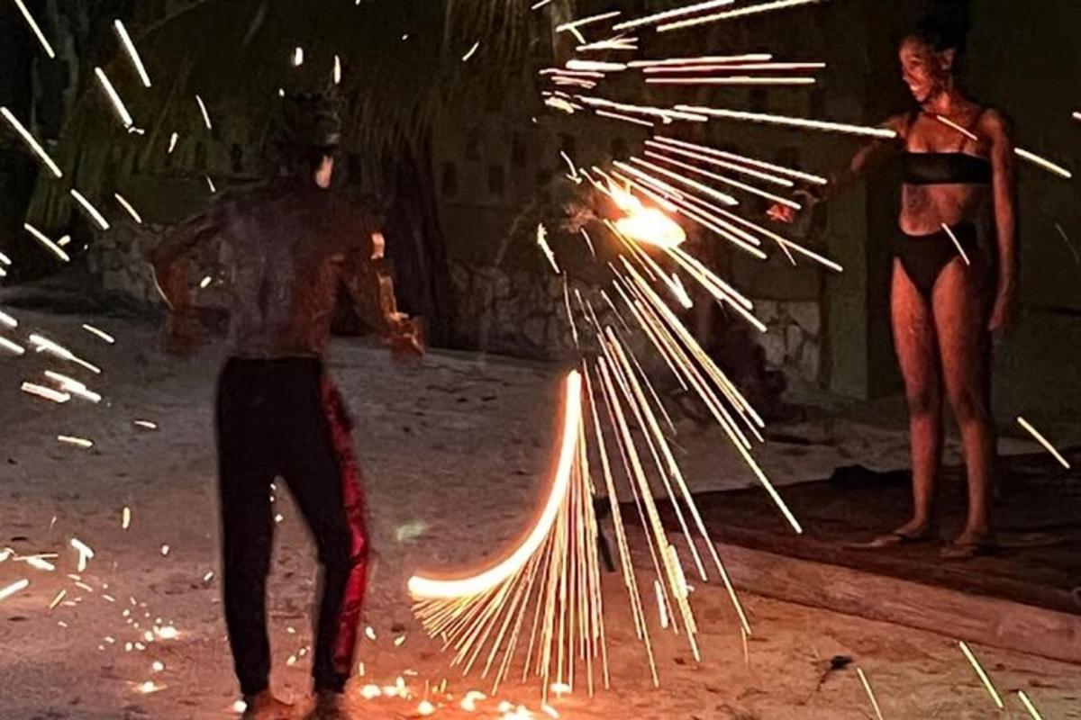 two people are holding a beam of fire