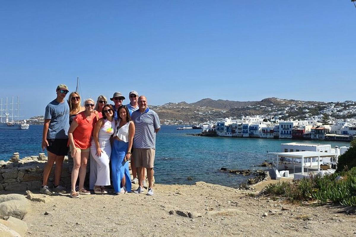 a group of people posing for a picture on a beach