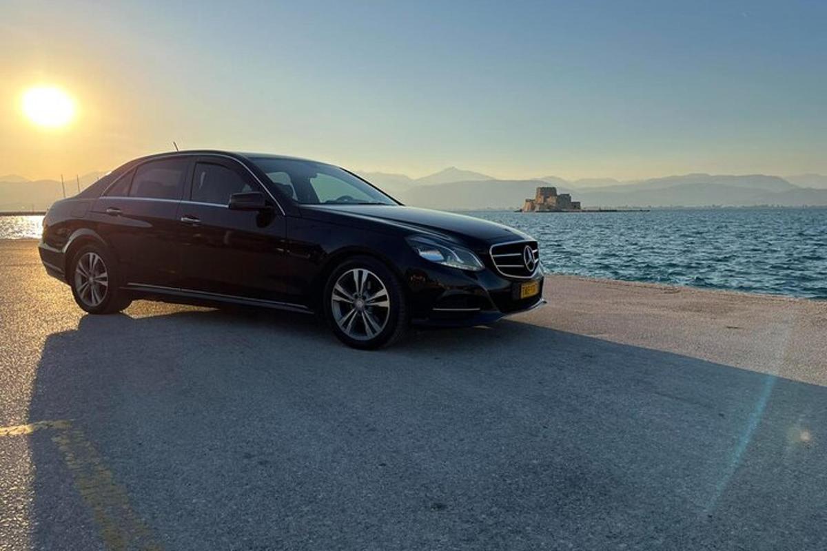 a black car parked next to a body of water