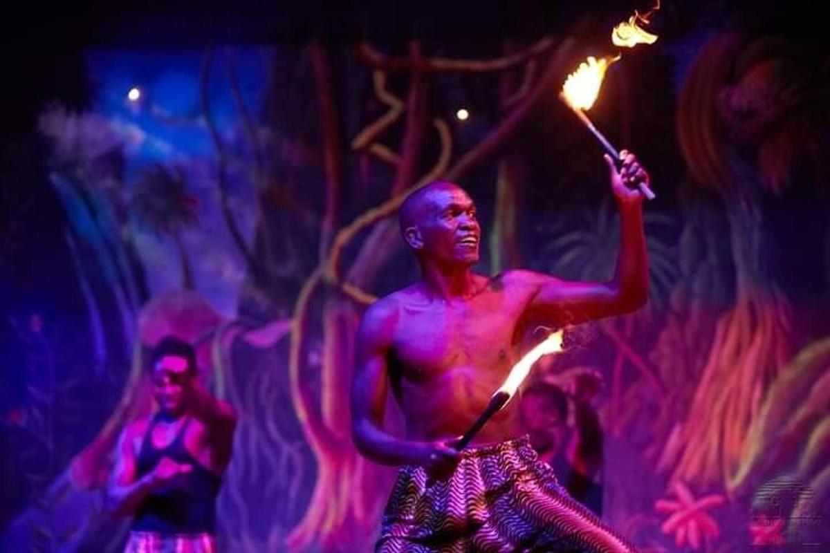 a man holding a torch in a performance