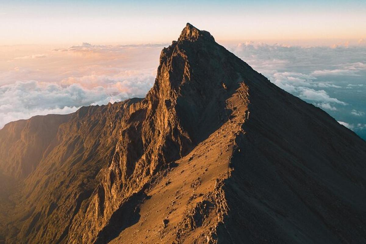 a view of a mountain with clouds in the background