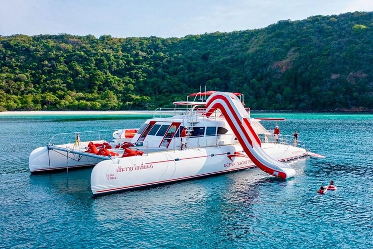 a boat with a slide in the middle of the water