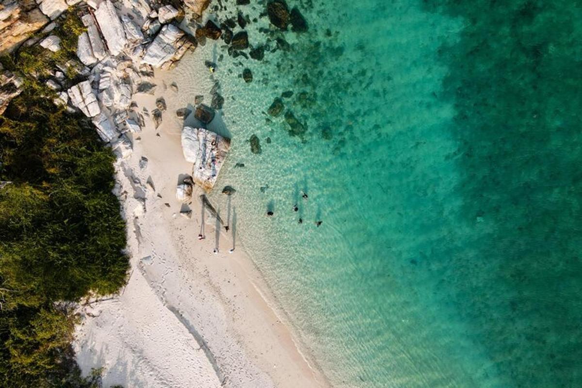an overhead view of a beach with a group of people
