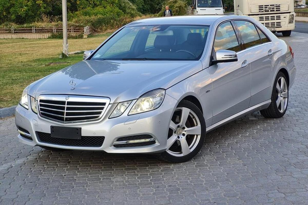 a silver car is parked on a street