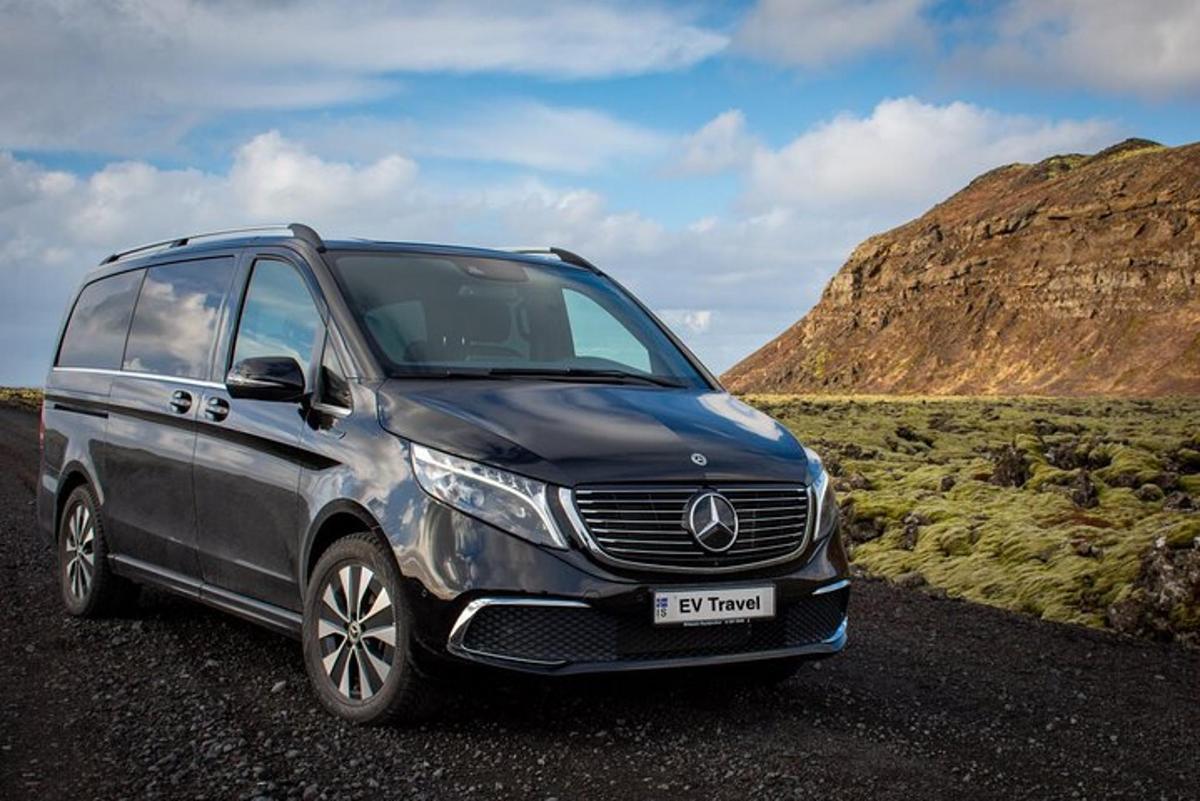 a silver mercedes benz minivan parked on a road