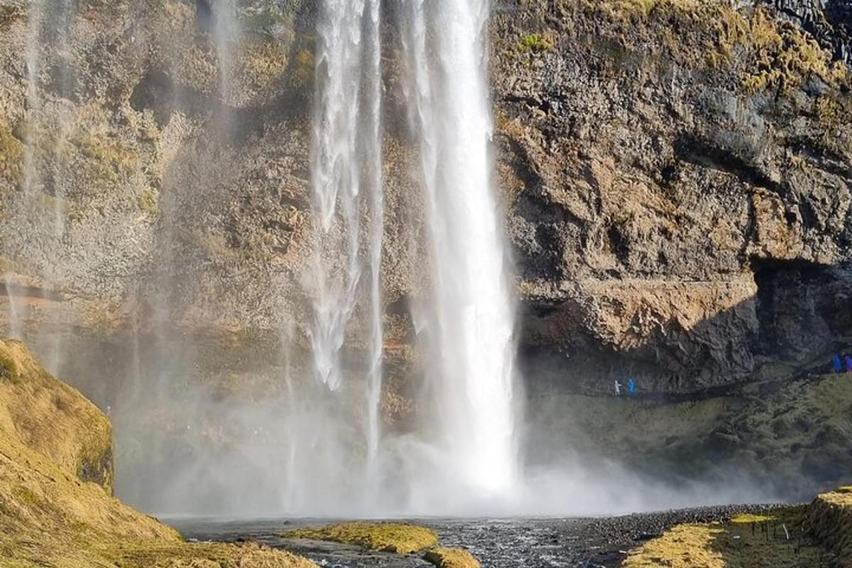 a waterfall in the middle of a rocky mountain