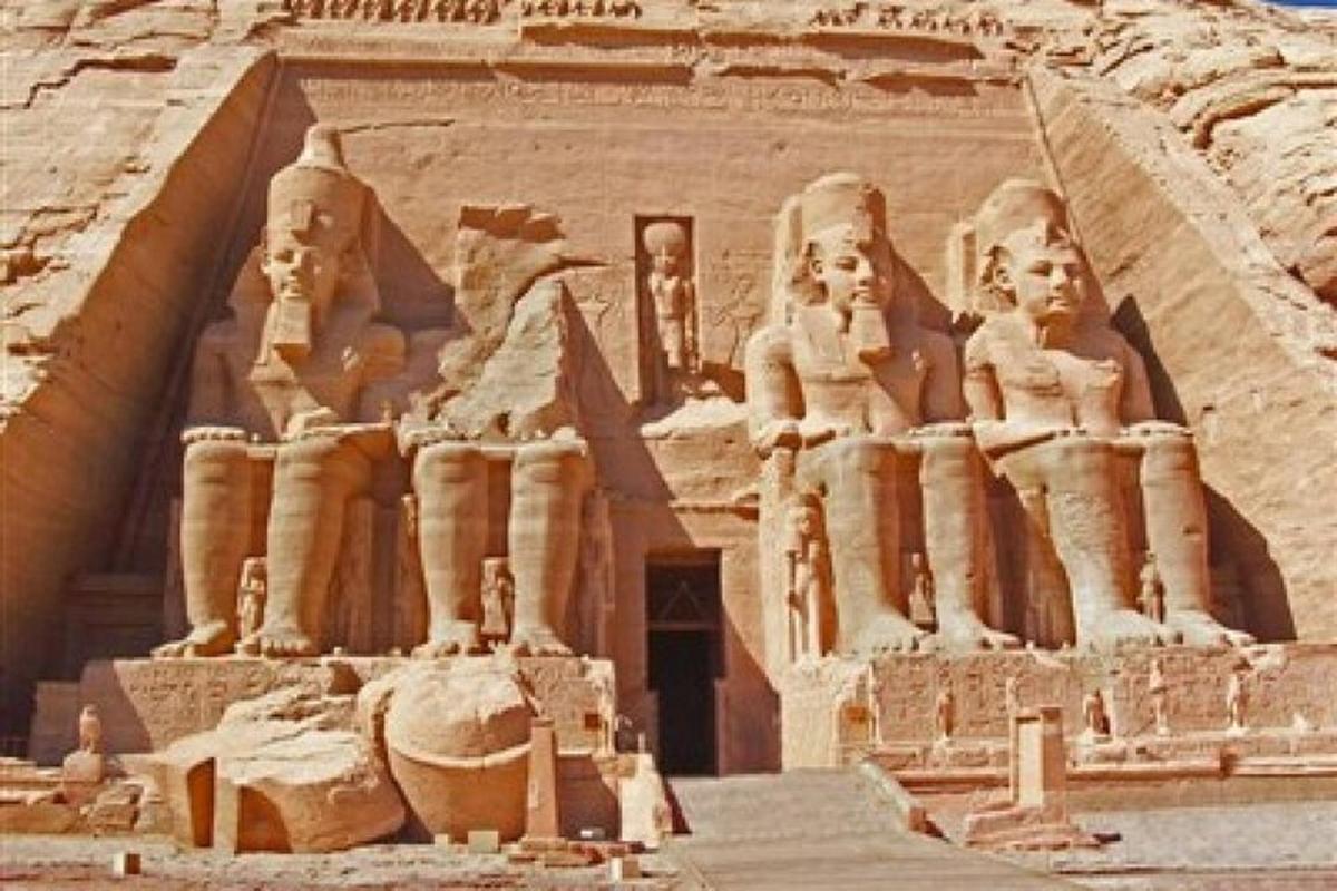 an ancient building with statues on the side of it