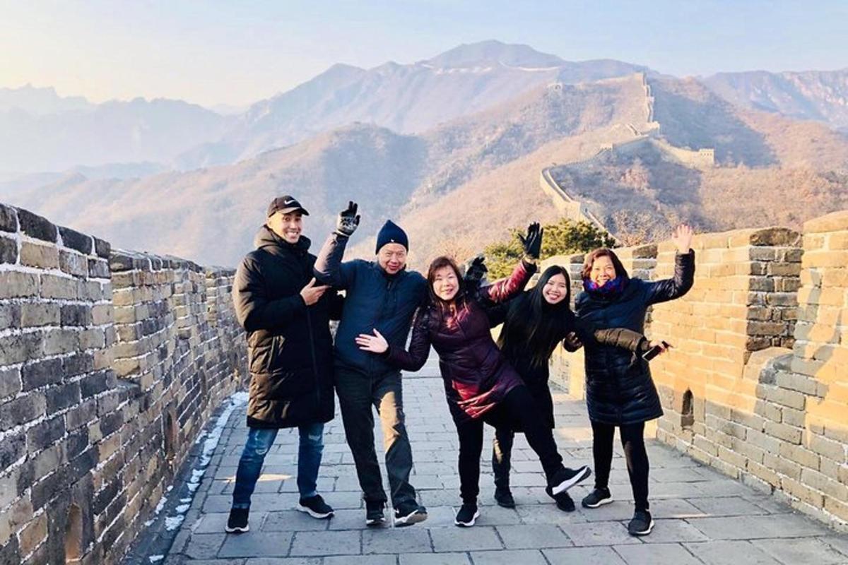 a group of people posing for a picture on the great wall