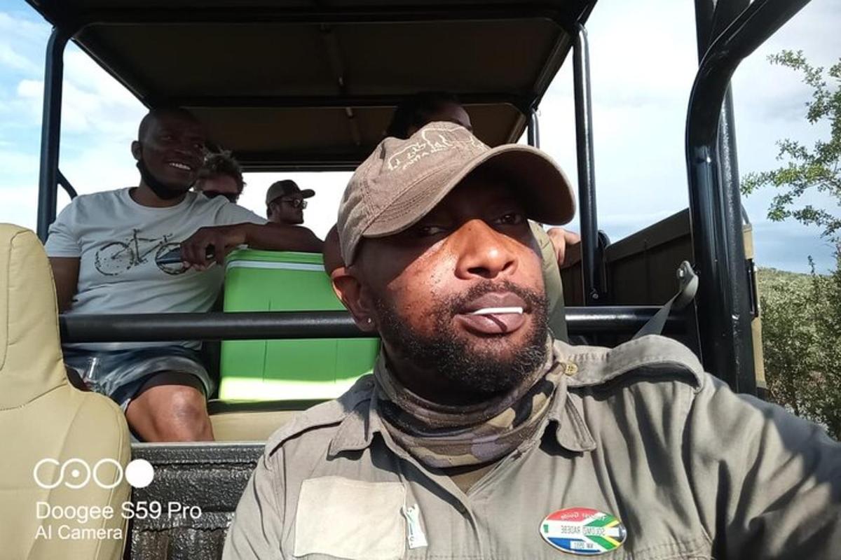 a man sticking his tongue out while riding in a truck