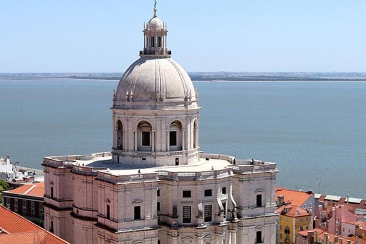 a building with a dome on top of it next to the water