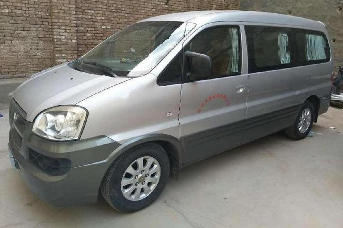 a silver van parked in a parking lot